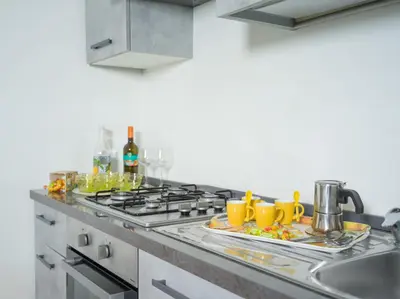 a kitchen with two plates of food and yellow mugs at Isola delle Femmine - Casetta del Pescatore in Isola delle Femmine