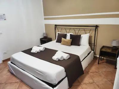 a bedroom with a bed with towels on it at Maison M&M in Palermo