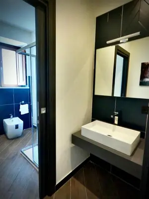 a bathroom with a white sink and a mirror at Ponticello Apartments in Palermo