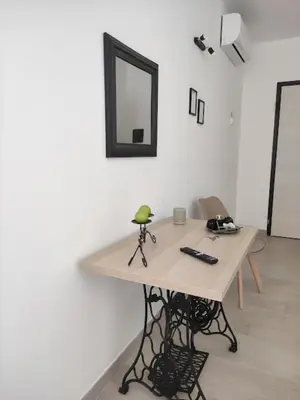 a table in a room with a mirror on the wall at Tacco e Punta bed&breakfast in Grisi