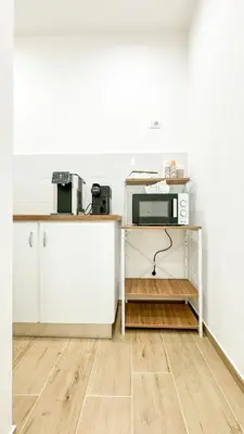 a kitchen with a table with a microwave on it at ARIA b&b in Terrasini