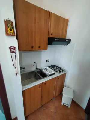 a small kitchen with a sink and a stove at A casa scalilla 2 in Palermo