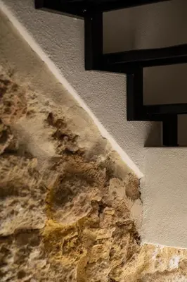 a wall with a stone wall with a wall at SantaTeresa19 Suite & Spa in Palermo