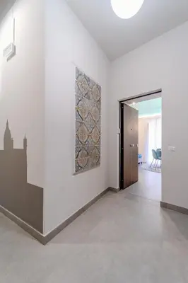 a white room with a door and a painting on a wall at Trabia25 Suite Palermo in Palermo