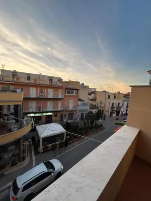 a car parked on a city street with buildings at MAESTRALE CASA VACANZA in Isola delle Femmine