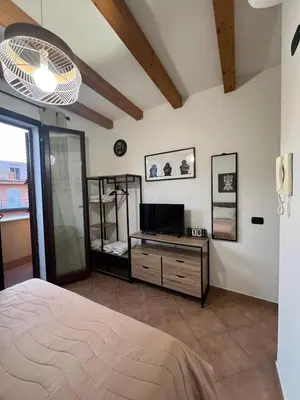 a bedroom with a bed and a television in it at MAESTRALE CASA VACANZA in Isola delle Femmine
