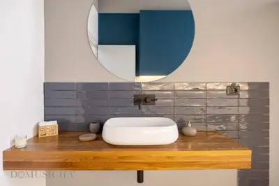 a bathroom with a white sink and a mirror at Real Tenuta Apartments By Domus Sicily in Palermo