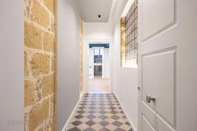 a hallway with a door and a checkered floor at Real Tenuta Apartments By Domus Sicily in Palermo