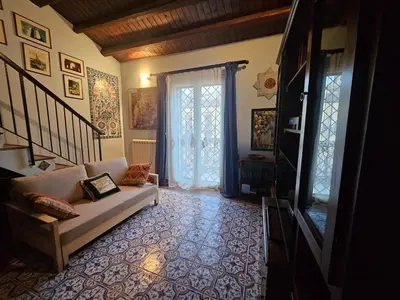 a living room with a couch and a window at casa Ennio by Villa Paola Ciminna in Ciminna