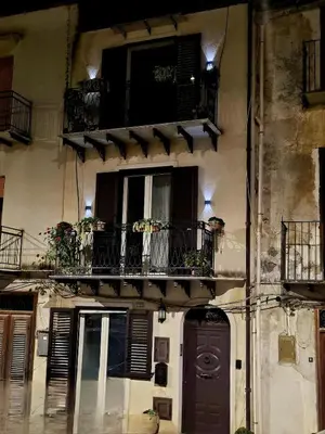 a building with a balcony with plants on it at casa Ennio by Villa Paola Ciminna in Ciminna