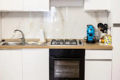 a kitchen with a stove and a sink at Noble Suite in Palermo
