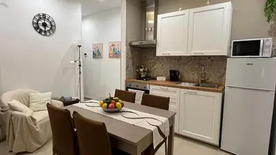 a kitchen with a table and a white refrigerator at Cuba Holiday House in Palermo
