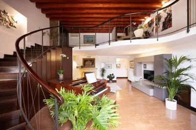 an open staircase in a house with plants at Behind the Cathedral apt in Palermo