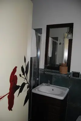 a bathroom with a sink and a mirror at Case Giannone in Santa Flavia