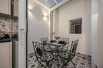 a dining room with a table and chairs at Roccella Apartments in Palermo