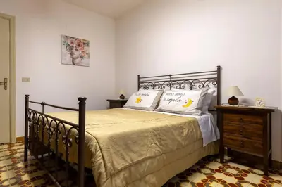 a bedroom with a large bed with two pillows at Casa Joya Apartment in Isola delle Femmine