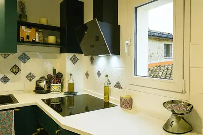 a kitchen with a sink and a window at Camera con bagno cucina e terrazza al Vicoletto al Massimo in Palermo