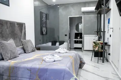 a bedroom with a large bed with towels on it at Suite del Principe - Prince's Suite. in Palermo