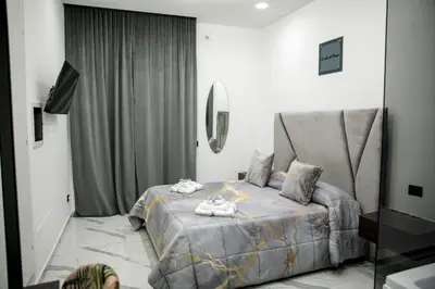 a bedroom with a bed and a mirror at Suite del Principe - Prince's Suite. in Palermo