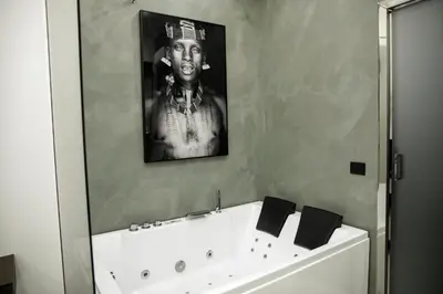a bathroom with a black and white picture of a man at Suite del Principe - Prince's Suite. in Palermo