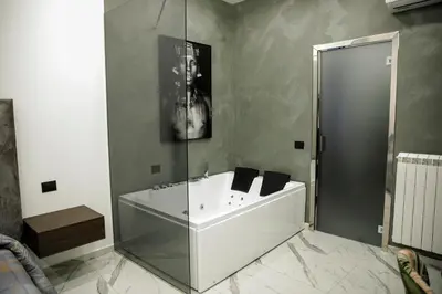 a bathroom with a bath tub and a shower at Suite del Principe - Prince's Suite. in Palermo