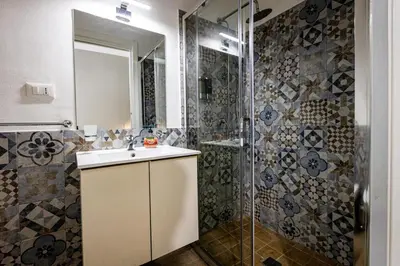a bathroom with a sink and a shower at Villafranca settantuno Apartments in Palermo