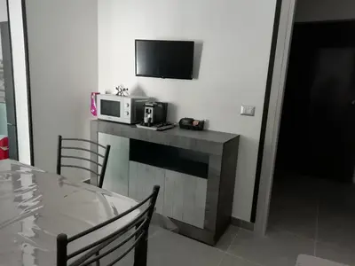 a kitchen with a table and a microwave on a counter at Casa Nino' in Palermo