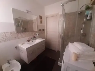 a bathroom with a toilet and a sink and a shower at Casa Ore-Tea in Palermo