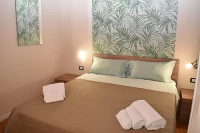 a bedroom with a bed with two towels on it at Kanat Apartment in Palermo