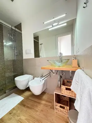 a bathroom with a sink and a toilet and a mirror at N&L Apartments Palermo in Palermo