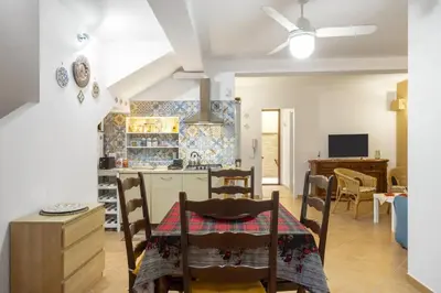 a kitchen and living room with a table and chairs at alloggio in Palermo