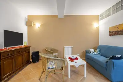 a living room with a blue couch and a table at alloggio in Palermo