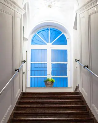 a stairway with a window and a potted plant at VICTORIO APARTMENT in Palermo