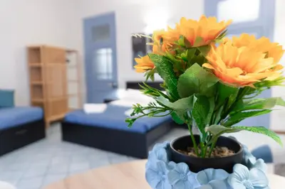 a vase with flowers on a table in a living room at VICTORIO APARTMENT in Palermo