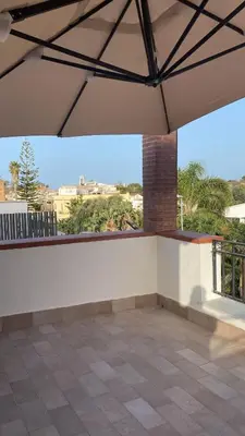 a patio with a roof with a view at Mondello Twentytwo House in Palermo