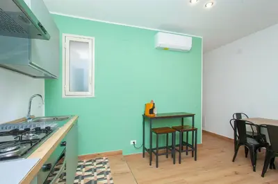 a kitchen with blue walls and a table and chairs at Mondello Twentytwo House in Palermo