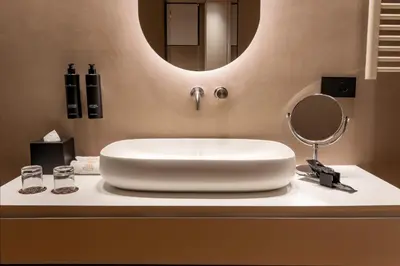 a bathroom with a white sink and a mirror at Five suite in Palermo