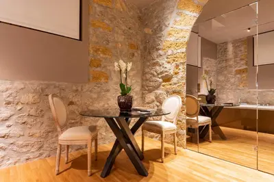 a dining room with a table and chairs at Five suite in Palermo