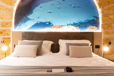 a bedroom with a bed with a painting on the wall at Five suite in Palermo