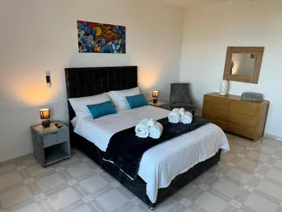 a bedroom with a bed with two towels on it at Mondello Luxury Apartment in Palermo