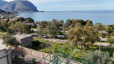 a view of the ocean from the balcony of a house at Mondello Luxury Apartment in Palermo