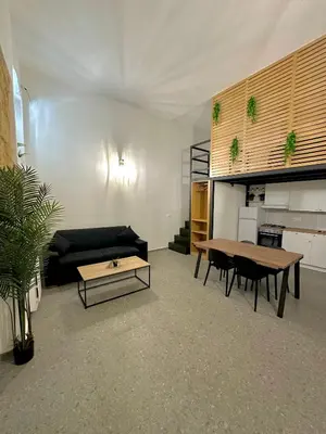 a living room with a couch and a table at Cala Peppa Loft Butera in Palermo