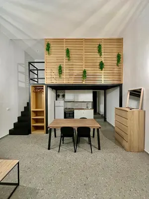 a room with a table and two chairs in it at Cala Peppa Loft Butera in Palermo