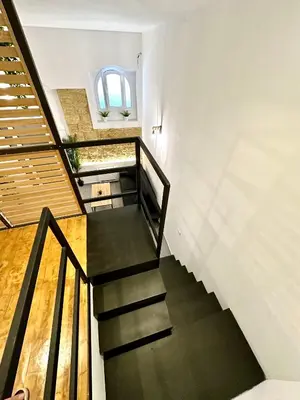 a staircase in a house with a window at Cala Peppa Loft Butera in Palermo