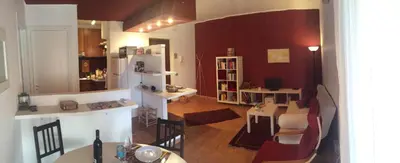 a living room with a kitchen and a dining room at Apartment 