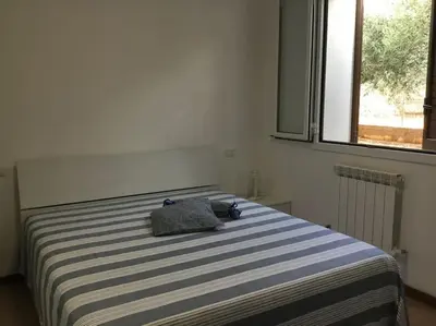a bedroom with a bed with two pillows on it at Casa Amuri in Scopello