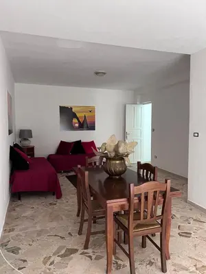 a living room with a table and a couch at Casa di Pippo in Trappeto