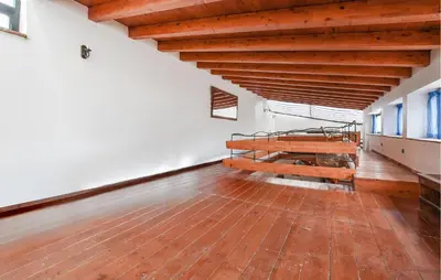 an empty room with a bed and a wooden floor at Amazing Home In Trappeto With Wifi in Trappeto