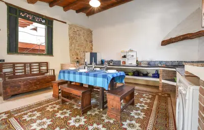 a kitchen with a table with a blue table cloth at Amazing Home In Trappeto With Wifi in Trappeto