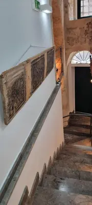 a set of stairs in a building with wooden railings at Le Antiche Porte in Palermo
